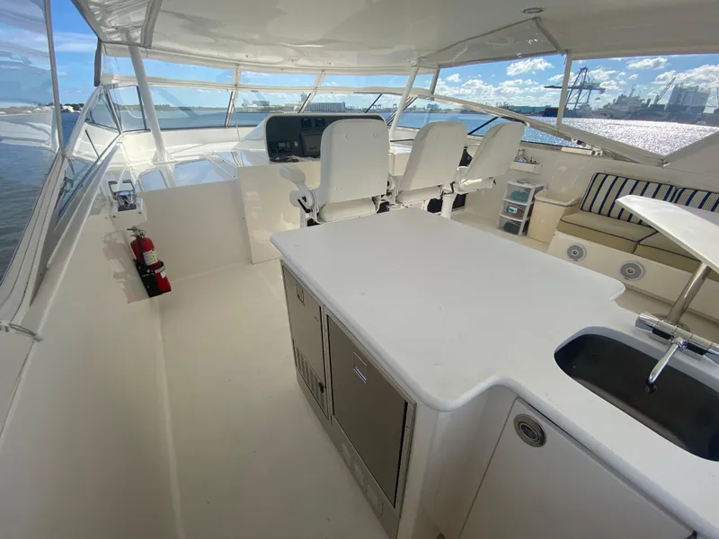 Slide: The Image of Luxurious 2005 Pacific Mariner 85 yacht interior with helm, seating, and kitchenette. - 44