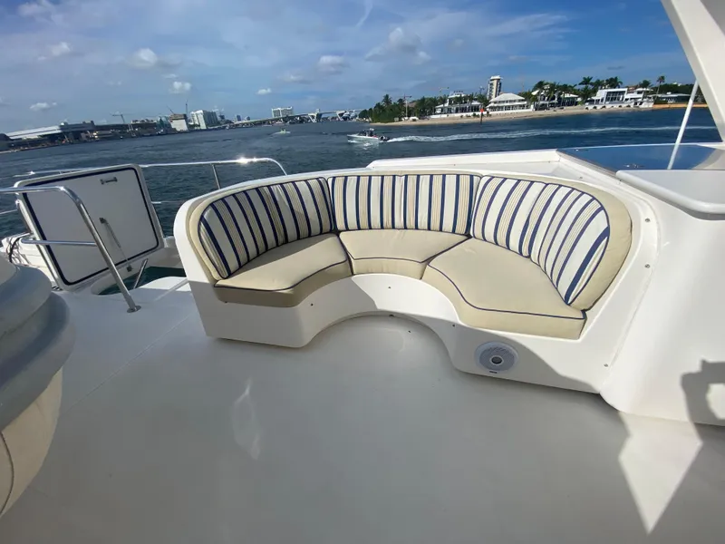 Slide: The Image of Luxury seating area on 2005 Pacific Mariner 85 yacht, overlooking scenic waterfront. - 49