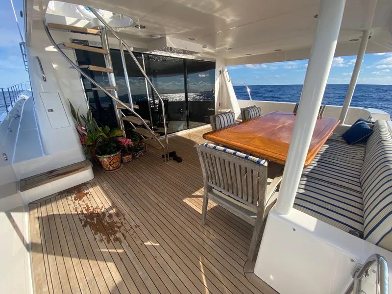Slide: The Image of Luxurious 2005 Pacific Mariner 85 yacht deck with seating, table, and ocean view. - 6