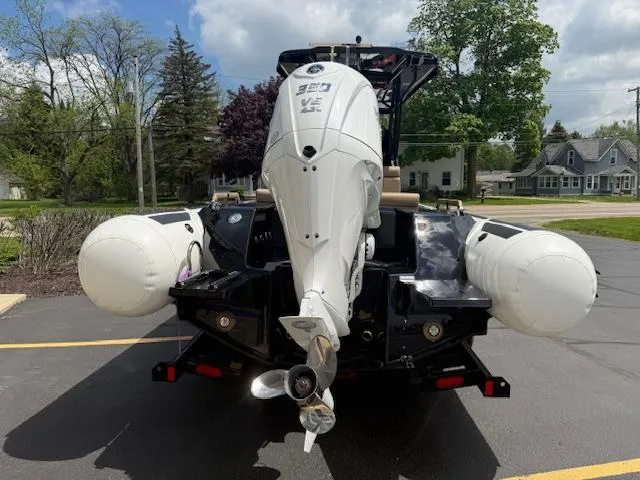 Slide: The Image of 2025 Brig Eagle 8 boat with powerful outboard motor, parked outdoors on a sunny day. - 11