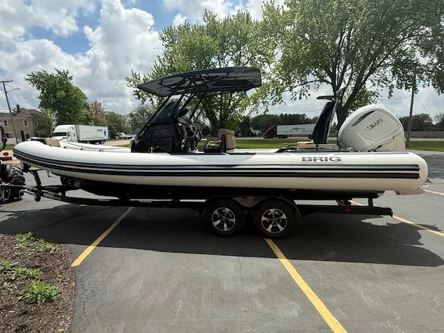 Slide: The Image of 2025 Brig Eagle 8 boat on trailer, parked outdoors under cloudy sky. - 2