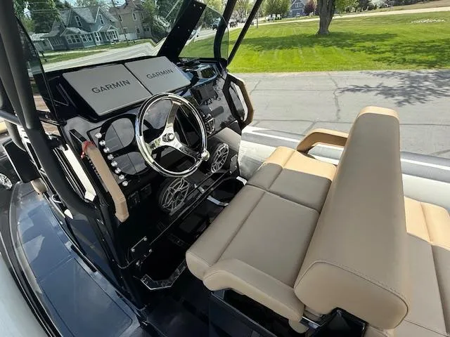 Slide: The Image of 2025 Brig Eagle 8 boat cockpit with Garmin navigation, beige seating, and modern steering wheel. - 4