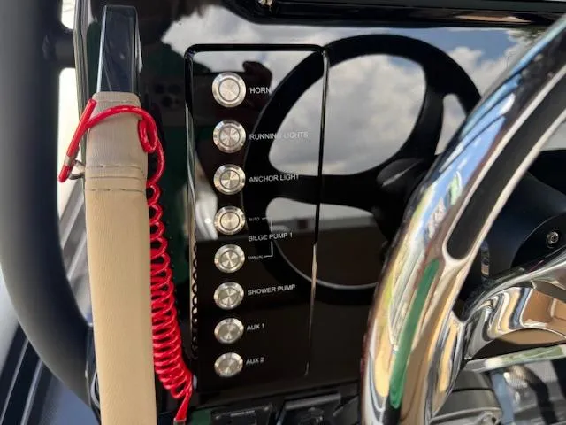 Slide: The Image of Control panel of 2025 Brig Eagle 8 boat with various switches and steering wheel. - 6