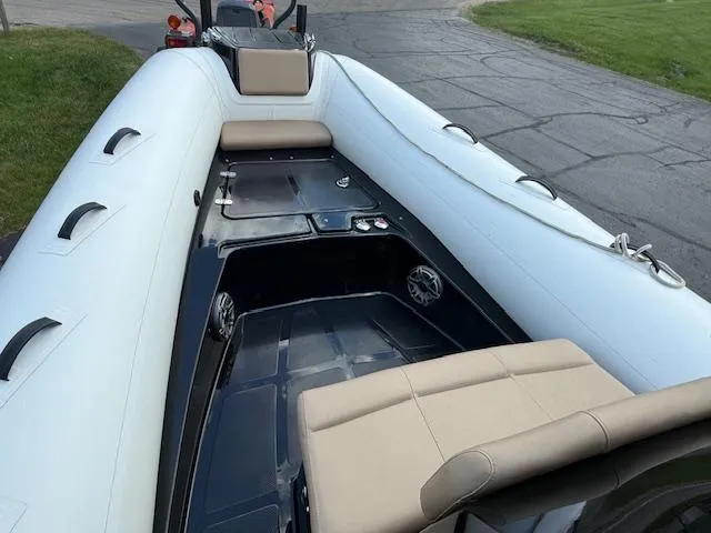 Slide: The Image of 2025 Brig Eagle 8 inflatable boat with beige seating and sleek design. - 8