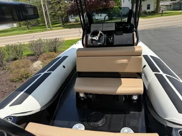 Slide: The Image of 2025 Brig Eagle 8 boat interior with beige seating and modern dashboard. - 9