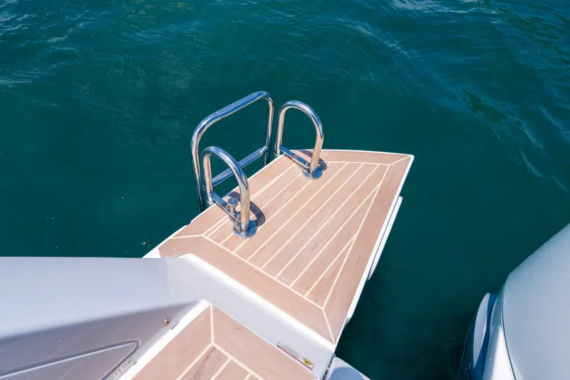 Slide: The Image of Swim platform with ladder on 2023 Pardo Yachts 38, floating on clear blue water. - 24