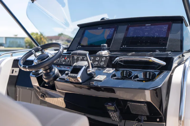 Slide: The Image of Helm of 2023 Pardo Yachts 38, featuring modern controls and navigation displays. - 38