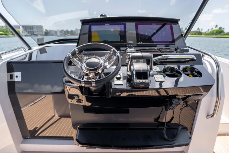 Slide: The Image of Helm of 2023 Pardo Yachts 38 with modern controls and navigation screens. - 39