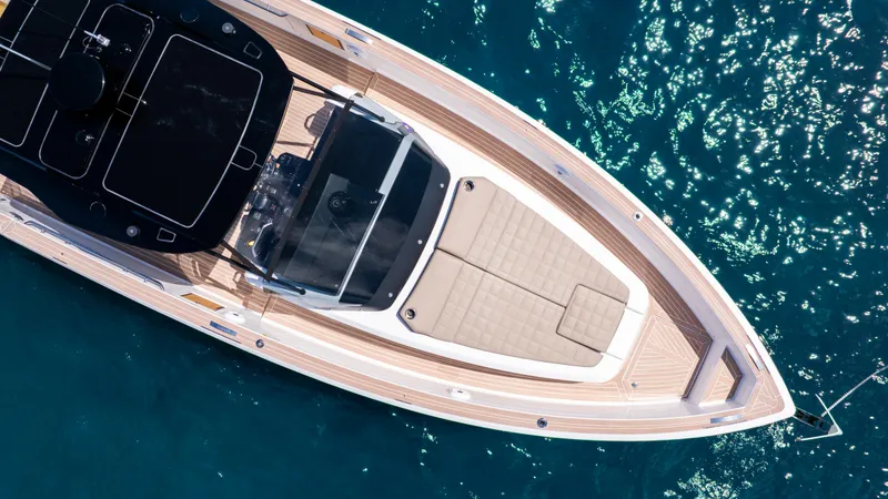 Slide: The Image of 2023 Pardo Yachts 38 deck with seating and table, overlooking the ocean. - 5