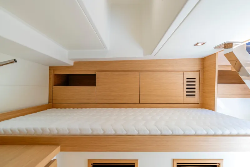 Slide: The Image of 2023 Pardo Yachts 38 interior cabin with wooden storage and comfortable bedding. - 58