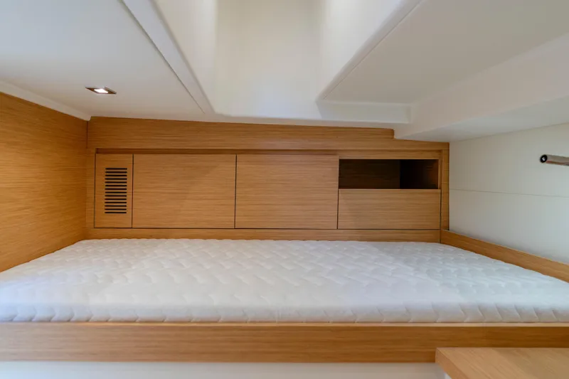 Slide: The Image of Luxurious cabin interior of 2023 Pardo Yachts 38 with wooden finish and cozy bedding. - 59