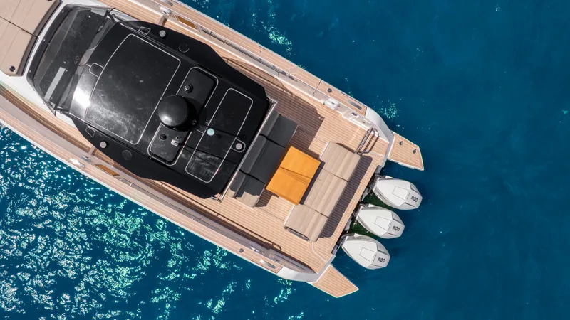 Slide: The Image of 2023 Pardo Yachts 38 with triple engines, elegant deck, and seating on blue water. - 6