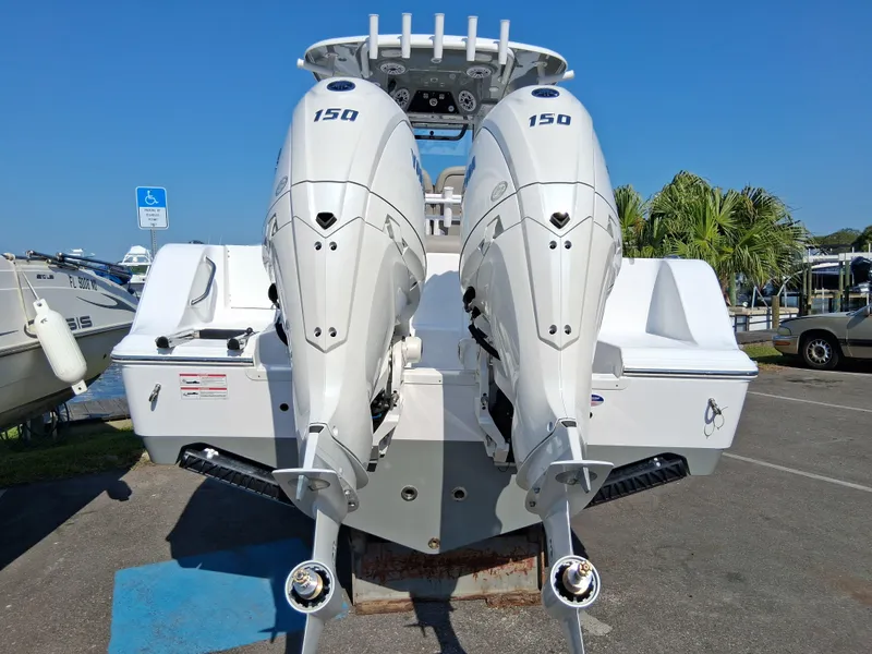 Slide: The Image of 2025 Sportsman Open 252 Center Console with twin 150 engines, parked outdoors. - 3