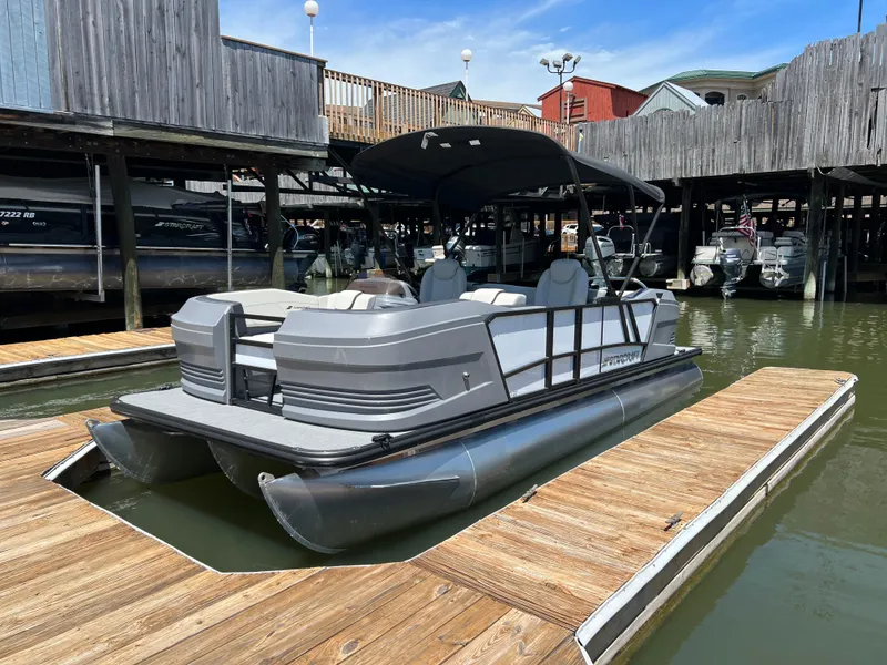 The Image of 2025 Starcraft GX 22 R DH Sport pontoon boat docked at a marina. - 0
