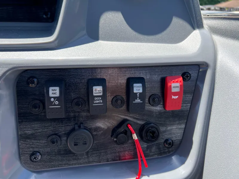 Slide: The Image of Control panel of 2025 Starcraft GX 22 R DH Sport boat with switches and ports. - 12