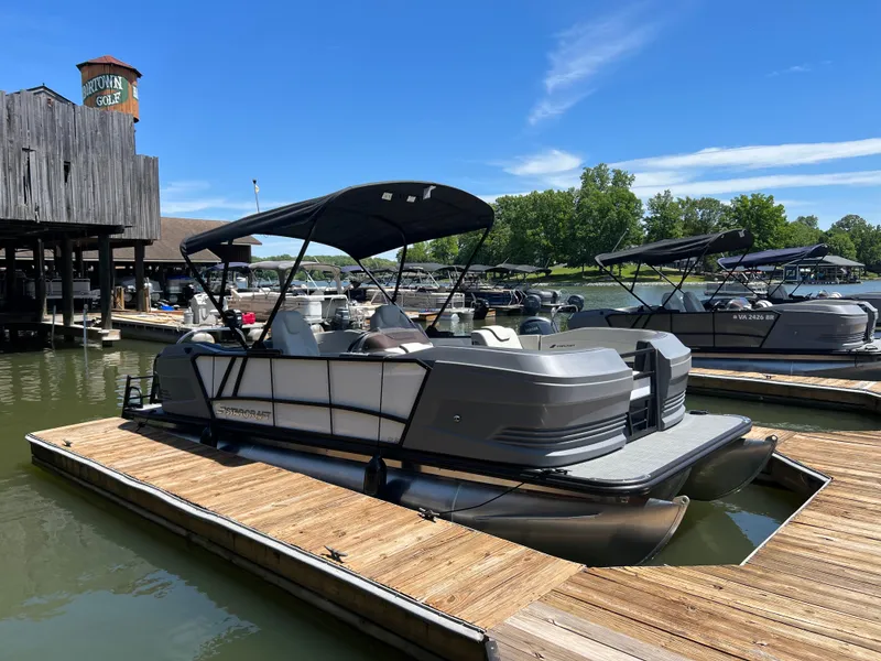 Slide: The Image of 2025 Starcraft GX 22 R DH Sport pontoon boat docked on a sunny day. - 3