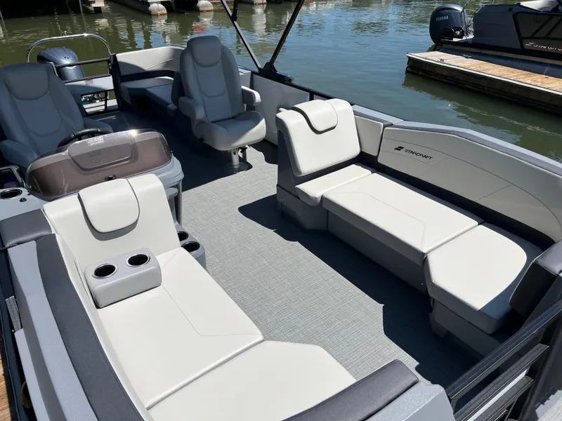 Slide: The Image of 2025 Starcraft GX 22 R DH Sport boat interior with plush seating and cup holders. - 5