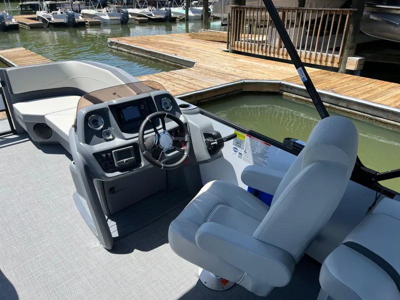 Slide: The Image of 2025 Starcraft GX 22 R DH Sport boat interior with modern helm and seating. - 7