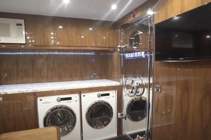 Slide: The Image of Laundry room in 2017 Hargrave Raised Pilothouse MY yacht with wood paneling and modern appliances. - 31