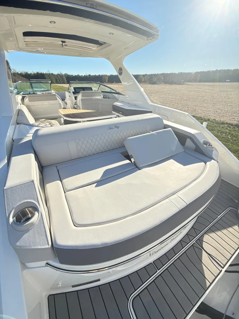 Slide: The Image of 2023 Sea Ray SLX 310 OB luxury boat with spacious seating and sleek design. - 12