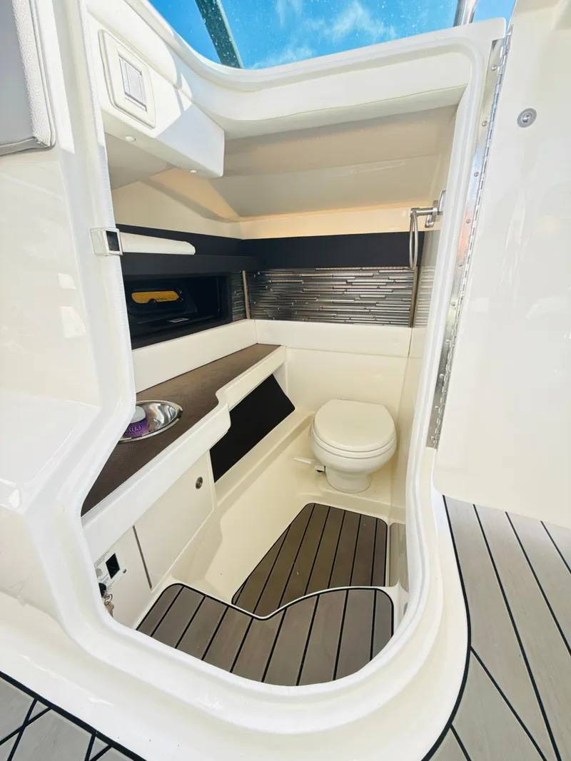 Slide: The Image of 2023 Sea Ray SLX 310 OB boat interior with modern bathroom amenities. - 17