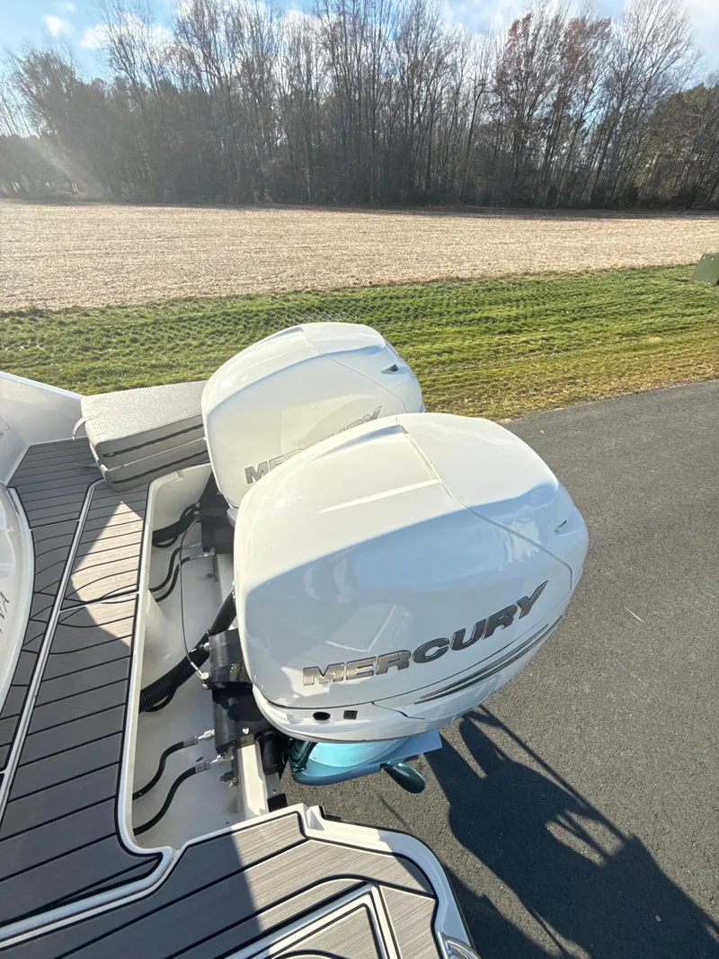 Slide: The Image of 2023 Sea Ray SLX 310 OB with twin Mercury outboard engines on a sunny day. - 24