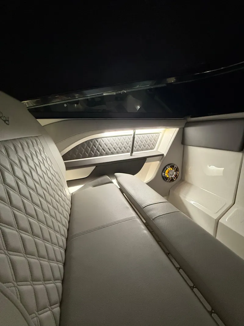 Slide: The Image of 2023 Sea Ray SLX 310 OB interior with quilted seating and ambient lighting. - 26