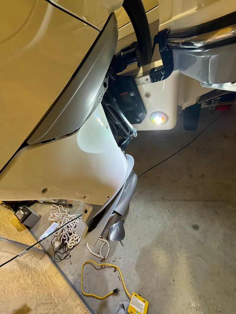 Slide: The Image of 2023 Sea Ray SLX 310 OB boat engine detail in a garage setting. - 31