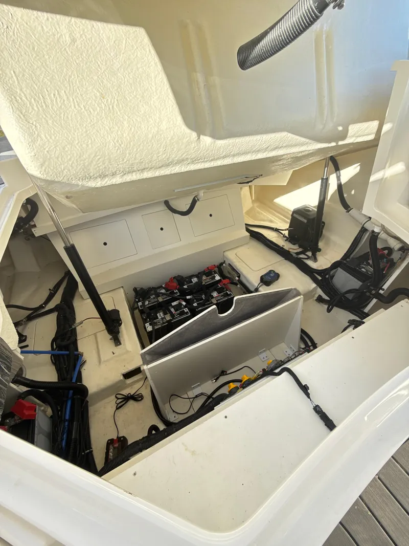 Slide: The Image of 2023 Sea Ray SLX 310 OB engine compartment with visible wiring and components. - 33