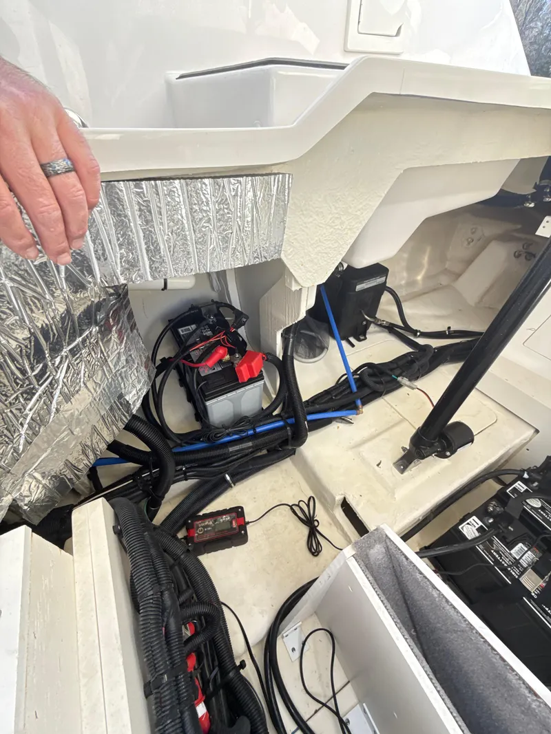 Slide: The Image of 2023 Sea Ray SLX 310 OB engine compartment with wiring and components visible. - 38