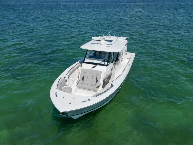 Slide: The Image of 2023 Pursuit S358 boat on clear blue water, aerial view. - 10