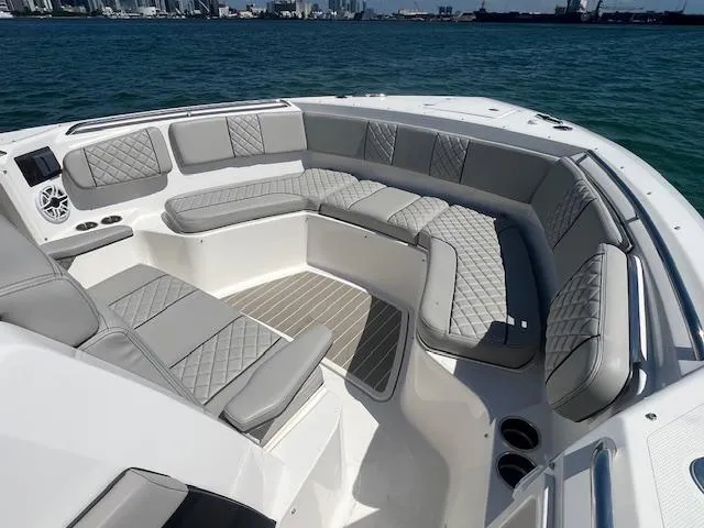 Slide: The Image of Luxurious seating area on 2023 Pursuit S358 boat with quilted cushions, ocean view. - 18
