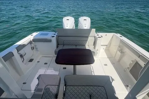 Slide: The Image of 2023 Pursuit S358 boat interior with seating and table on open water. - 20