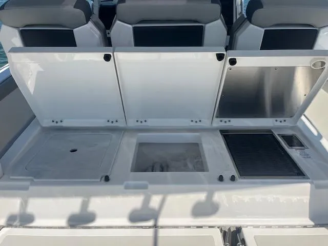 Slide: The Image of 2023 Pursuit S358 boat interior with storage compartments and seating. - 22
