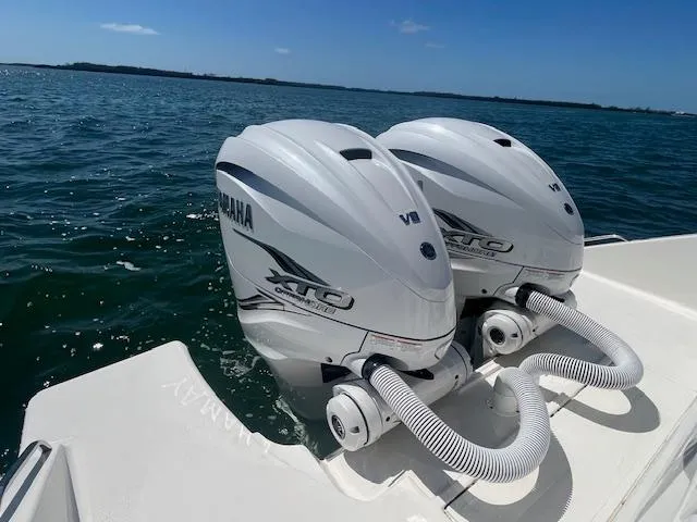 Slide: The Image of Twin Yamaha outboard engines on a 2023 Pursuit S358 boat in open water. - 24