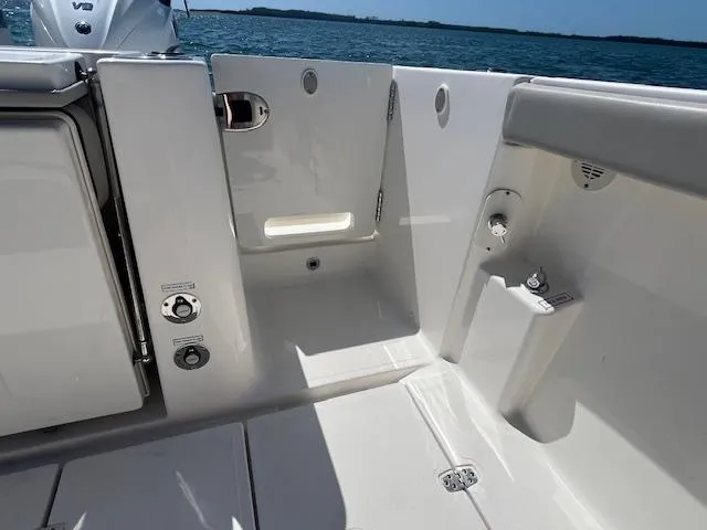 Slide: The Image of 2023 Pursuit S358 boat interior with sleek white design and ocean backdrop. - 25