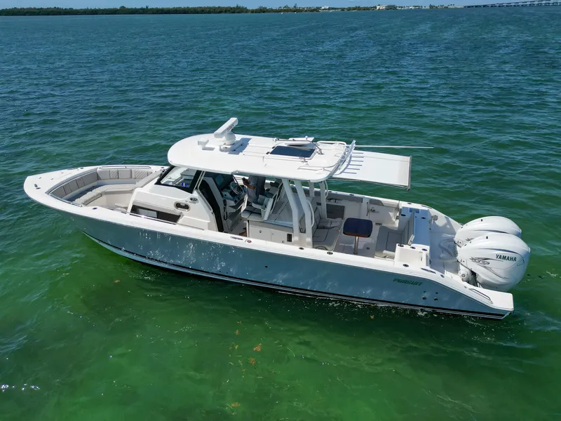 Slide: The Image of 2023 Pursuit S358 boat on clear blue water, featuring twin Yamaha engines. - 4