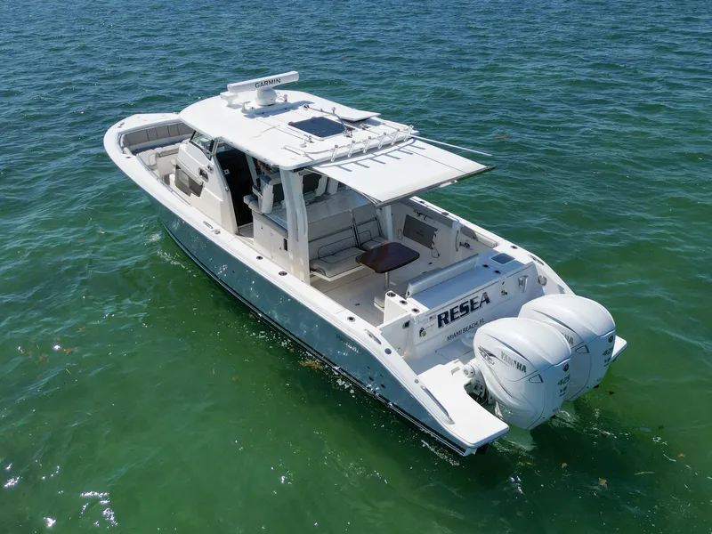 Slide: The Image of 2023 Pursuit S358 boat on water, featuring twin engines and sleek design. - 5