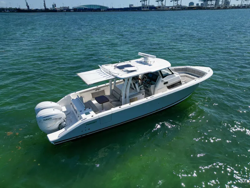 Slide: The Image of 2023 Pursuit S358 boat on clear water with twin Yamaha engines. - 7