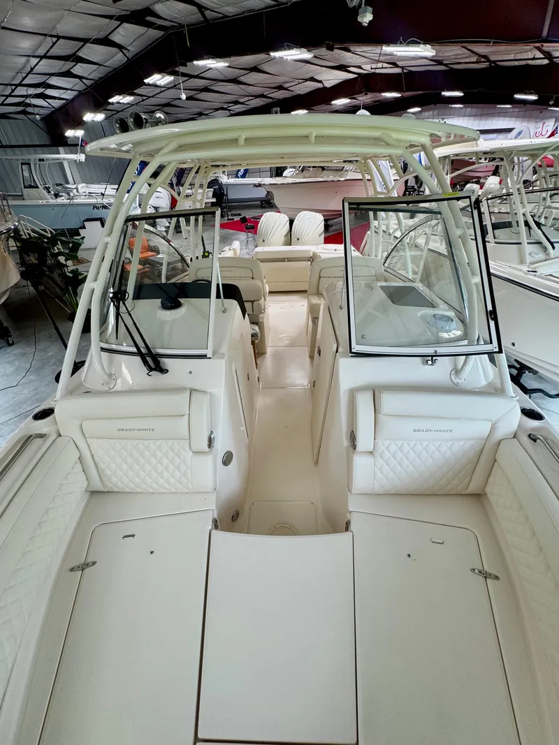 Slide: The Image of 2025 Grady-White Freedom 285 boat interior in showroom, featuring spacious seating and modern design. - 12