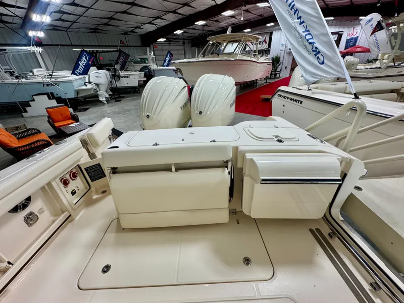 Slide: The Image of 2025 Grady-White Freedom 285 boat interior with dual Yamaha engines in showroom. - 5