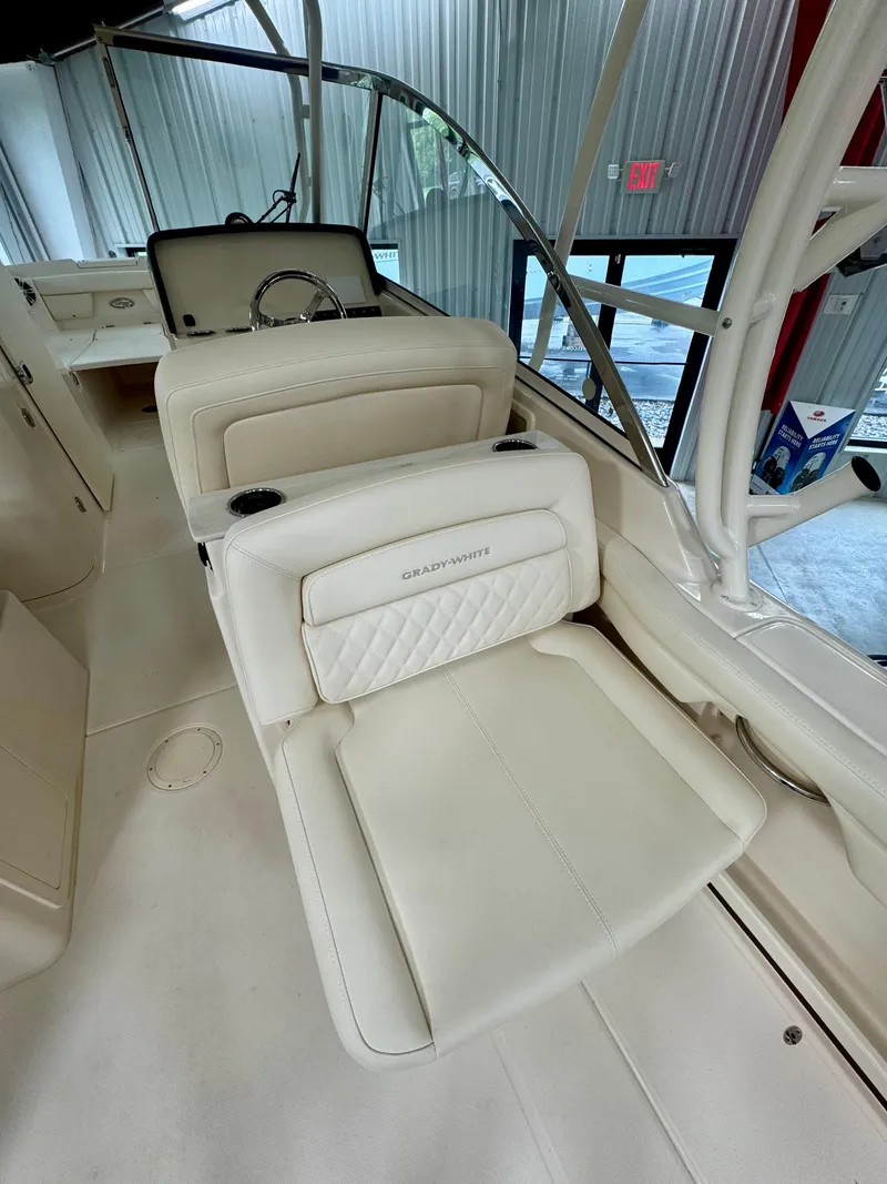 Slide: The Image of 2025 Grady-White Freedom 285 boat interior with luxurious seating and steering wheel. - 6
