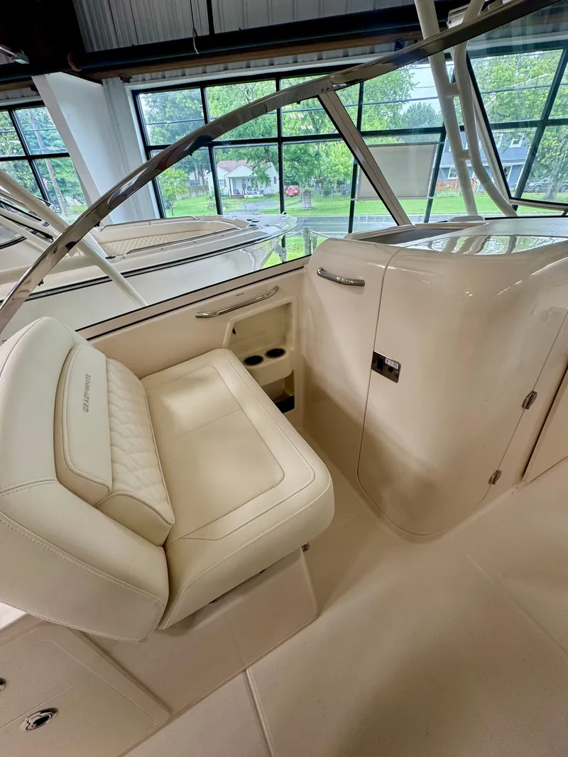 Slide: The Image of 2025 Grady-White Freedom 285 boat interior with cushioned seating and storage compartment. - 8
