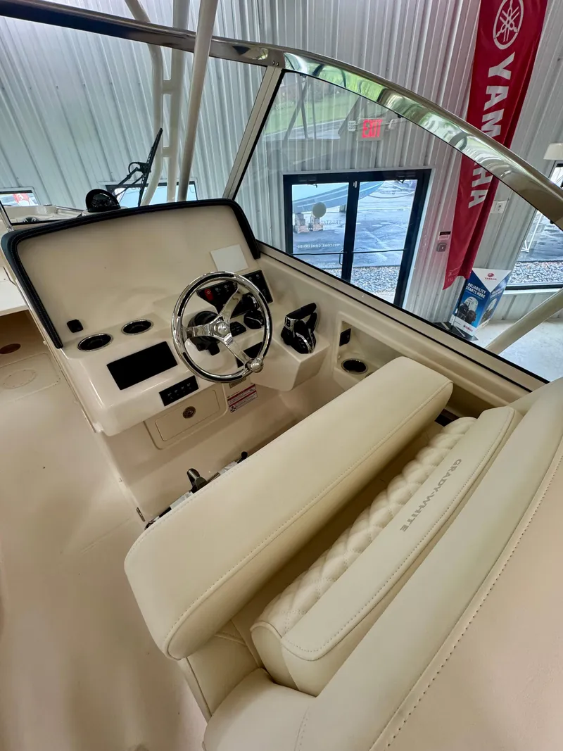 Slide: The Image of 2025 Grady-White Freedom 285 boat interior with steering wheel and controls. - 9
