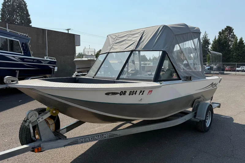 The Image of 1987 Duckworth Pro Steelhead boat on trailer with canopy, parked outdoors. - 0