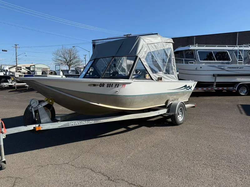 Slide: The Image of 1987 Duckworth Pro Steelhead boat on trailer, with canopy and Mercury outboard motor. - 1