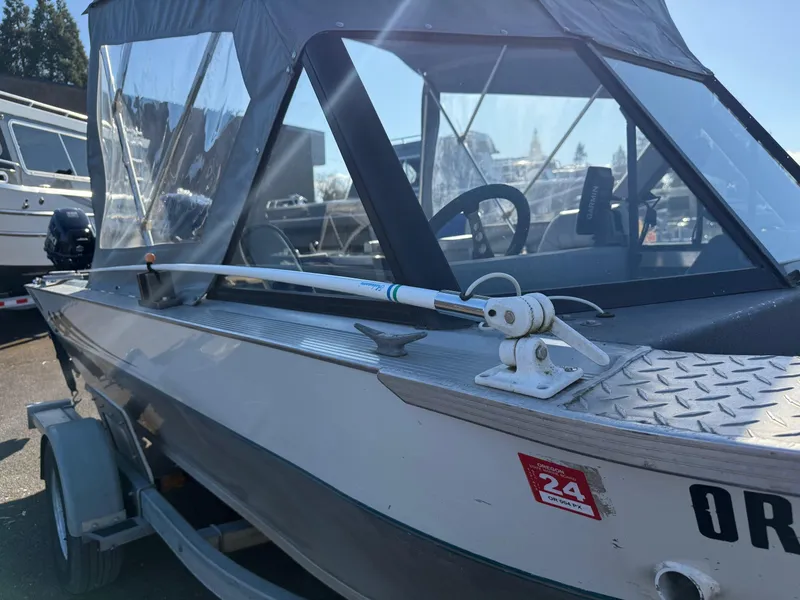 Slide: The Image of 1987 Duckworth Pro Steelhead boat interior with motor, featuring gray carpeted seating and storage. - 10