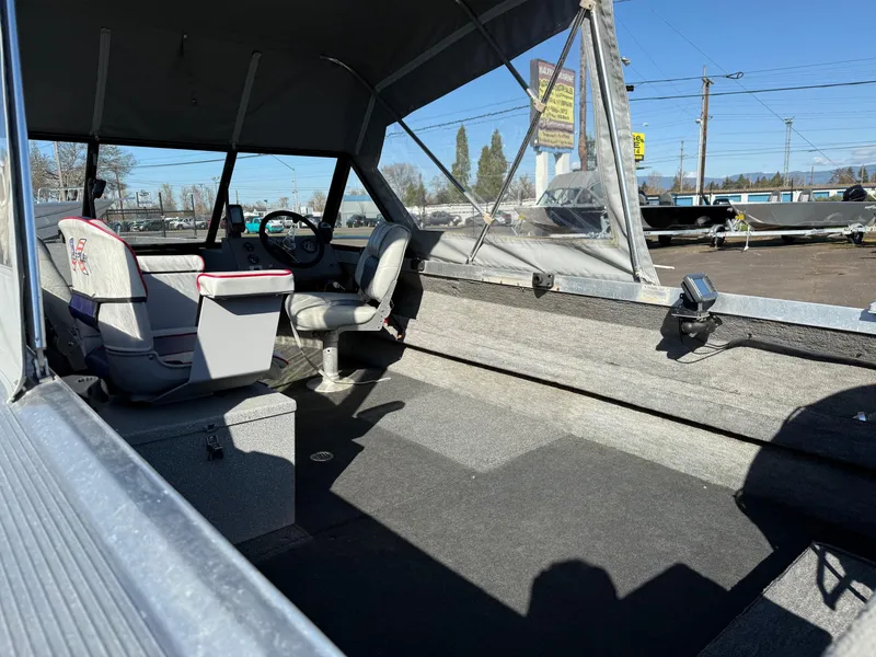 Slide: The Image of 1987 Duckworth Pro Steelhead boat dashboard with steering wheel and navigation equipment. - 14