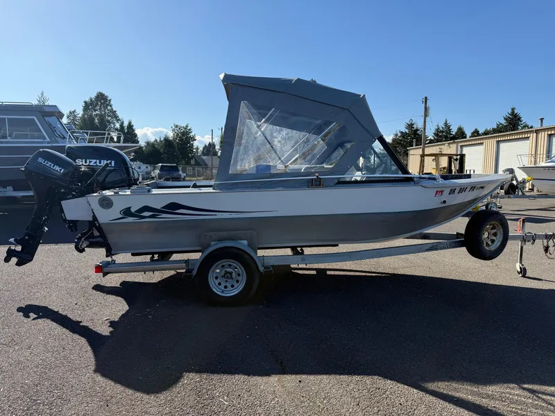 Slide: The Image of 1987 Duckworth Pro Steelhead boat interior with seating and steering wheel, parked outdoors. - 7