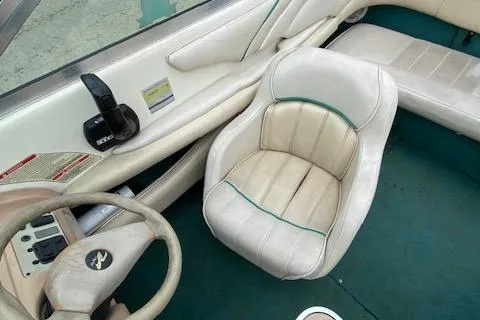 Slide: The Image of 1995 Sea Ray 200 Signature boat interior with white seating and green carpet. - 12